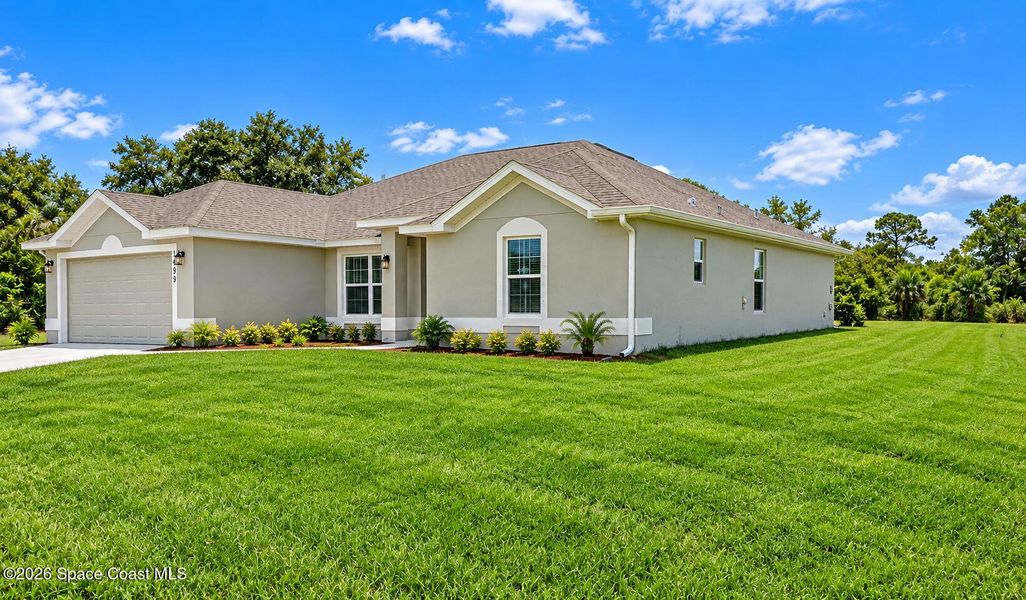 Front exterior of a new home in Palm Bay, Palm Bay, FL, highlighting curb appeal (Image 2). Front exterior of a new home in Palm Bay, Palm Bay, FL, highlighting curb appeal (Image 2).