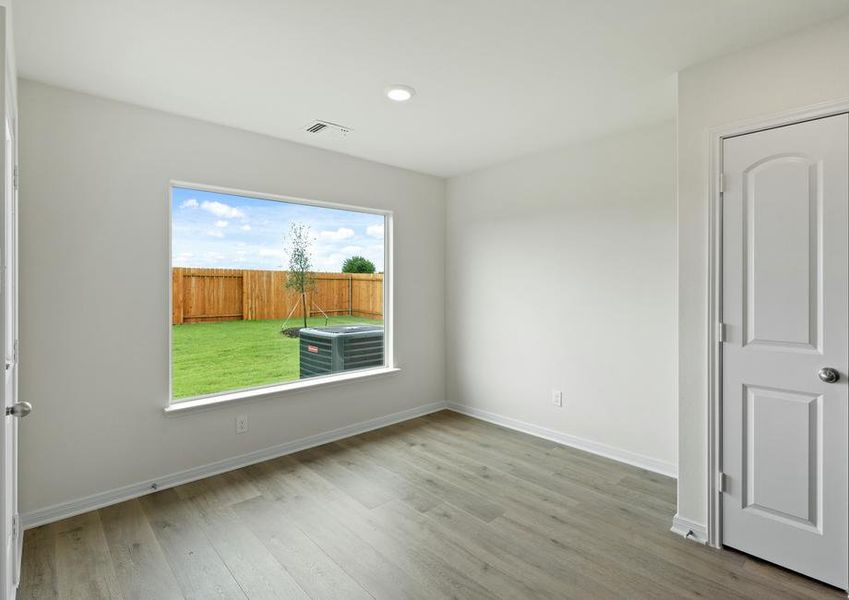 The dining room of sits right off of the kitchen and has a large window.