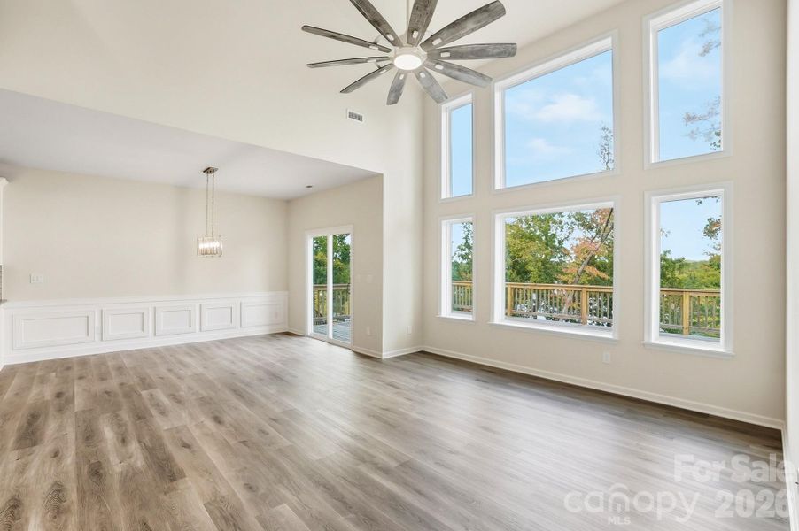 Great room soars with ceilings and natural light flooding in