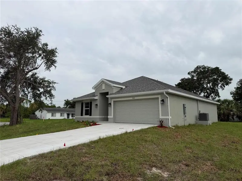 Front exterior of a new home in , Port Charlotte, FL, highlighting curb appeal (Image 2). Front exterior of a new home in , Port Charlotte, FL, highlighting curb appeal (Image 2).