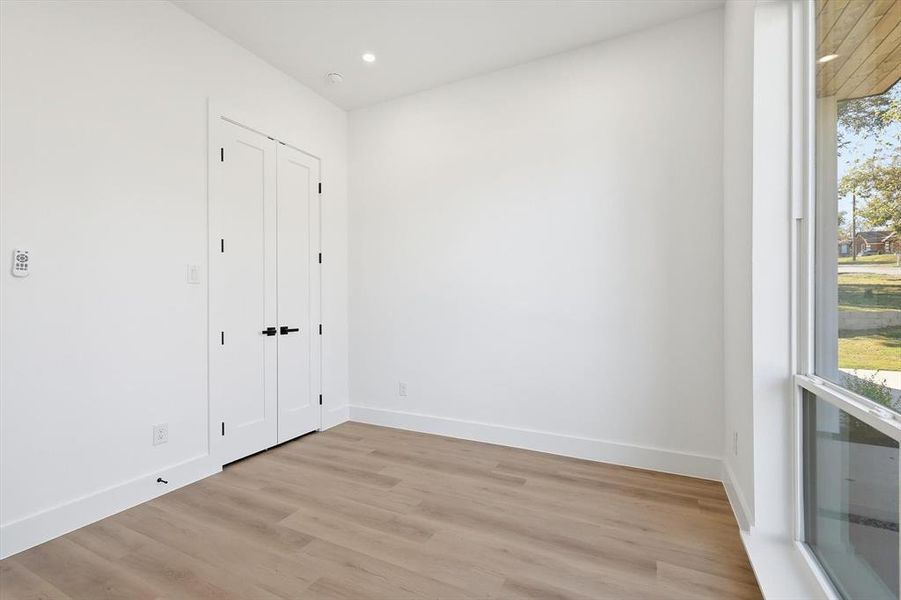 Unfurnished bedroom featuring light wood-style floors, recessed lighting, and a closet Unfurnished bedroom featuring light wood-style floors, recessed lighting, and a closet
