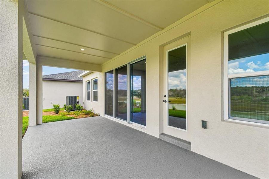 Exterior details and patio area of a home in Oakfield at Mount Dora Village Series, Mount Dora (Image 4).