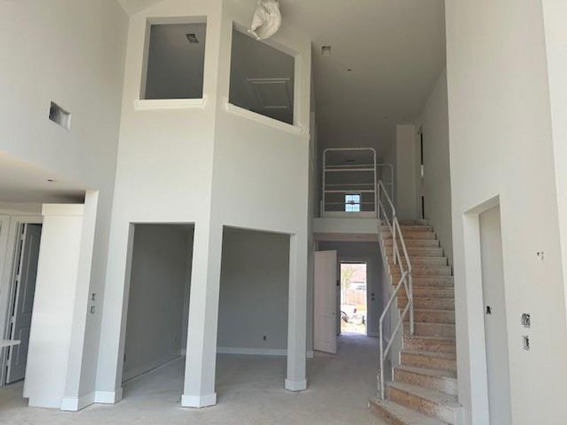 View of the stairs and dining room and entry.