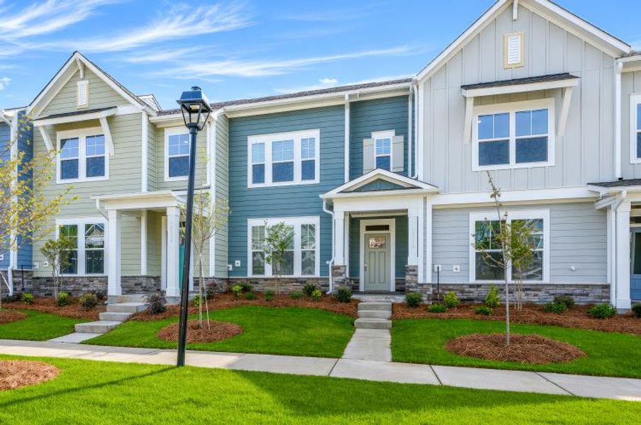 Front exterior of a new home in North Creek Village - Townhomes, Huntersville, NC, highlighting curb appeal (Image 1). Front exterior of a new home in North Creek Village - Townhomes, Huntersville, NC, highlighting curb appeal (Image 1).