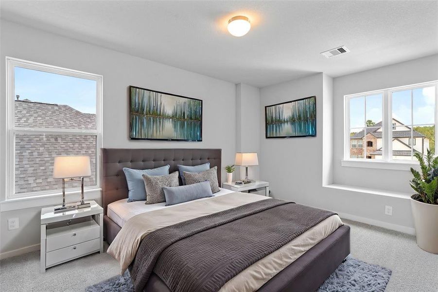 Secondary bedroom features plush carpet, custom paint, high ceilings, and a large window with privacy blinds.