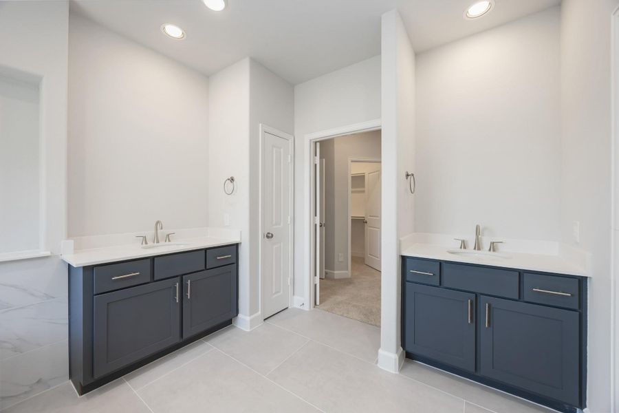 Spa-like Splendor: Dual vanities, a roomy linen closet, and a secluded water closet are set amid abundant space for an everyday spa experience right at home. Spa-like Splendor: Dual vanities, a roomy linen closet, and a secluded water closet are set amid abundant space for an everyday spa experience right at home.
