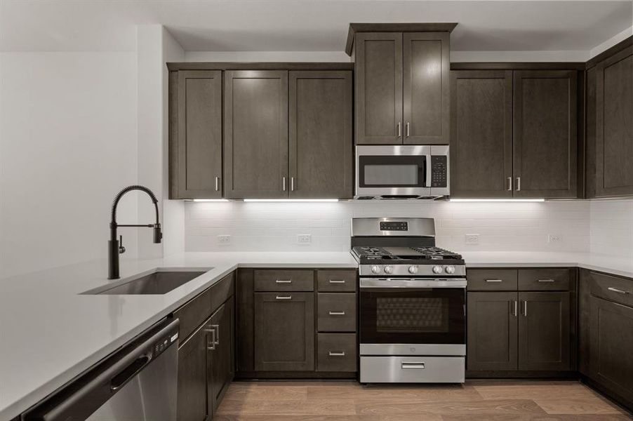 This over the top kitchen offers striking cabinetry, gorgeous countertops and contemporary appliances artfully blended to create a dream kitchen!