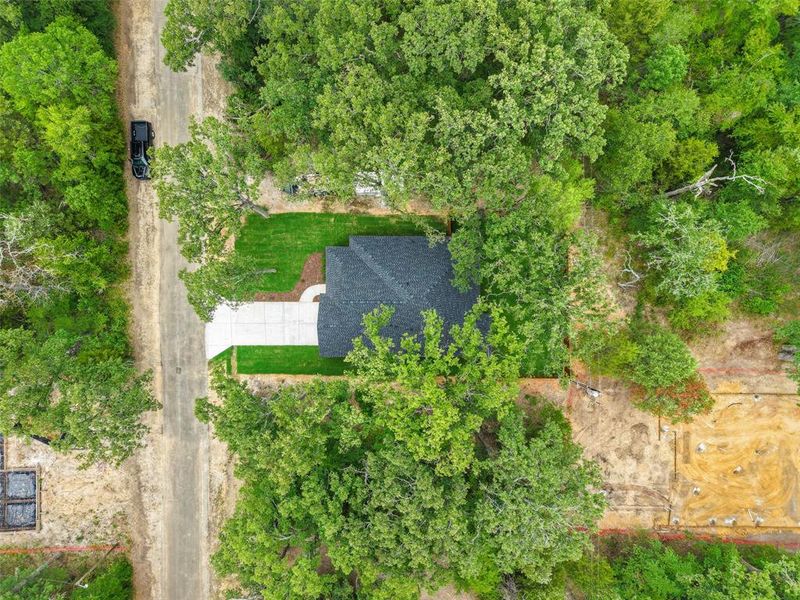 Aerial perspective showcasing a property surrounded by mature trees Aerial perspective showcasing a property surrounded by mature trees