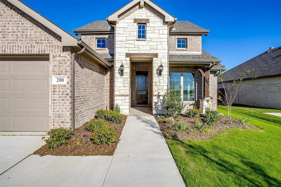 View of front facade with a front lawn and a garage