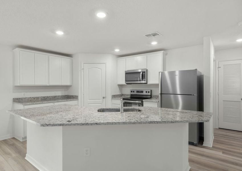 The kitchen comes chef-ready with stainless steel appliances