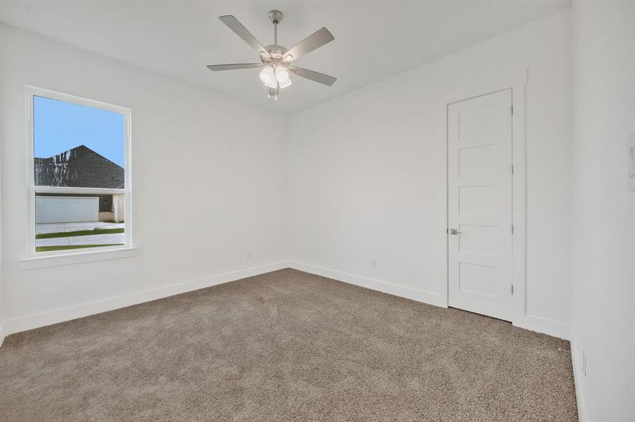 Spare room featuring carpet floors, a ceiling fan, and baseboards Spare room featuring carpet floors, a ceiling fan, and baseboards
