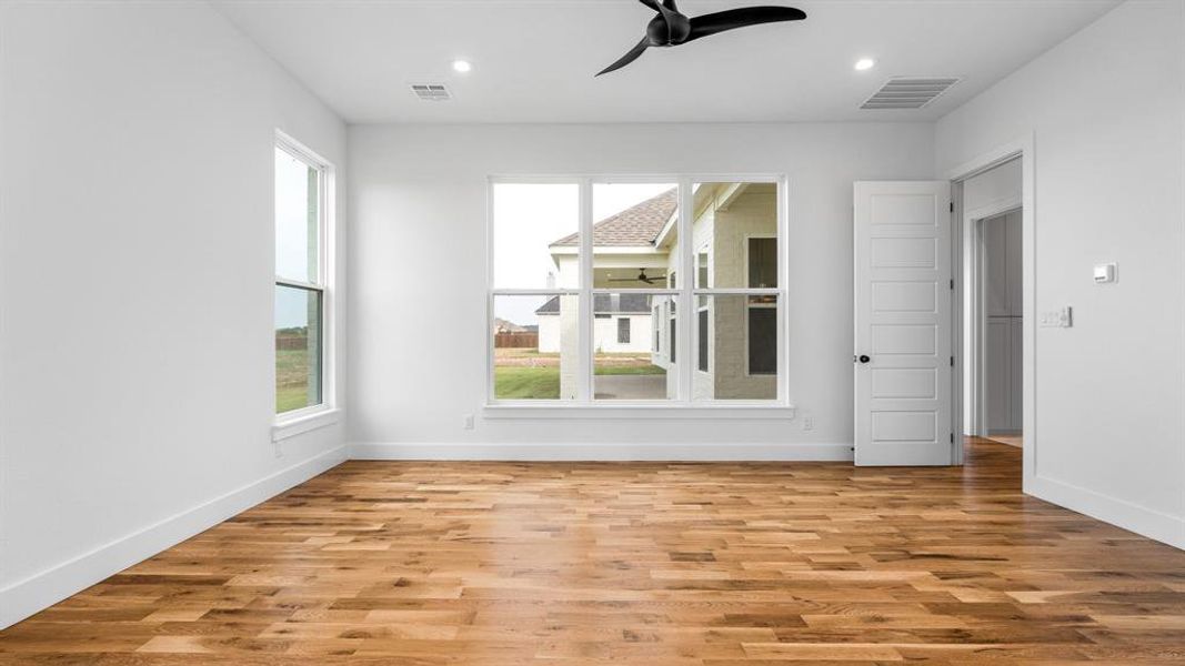 Empty room featuring light hardwood / wood-style floors and ceiling fan