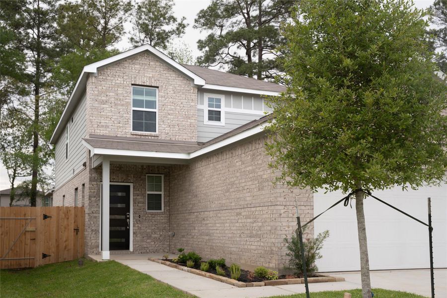 Front exterior of a new home in Lakes at Black Oak, Magnolia, TX, highlighting curb appeal (Image 1).