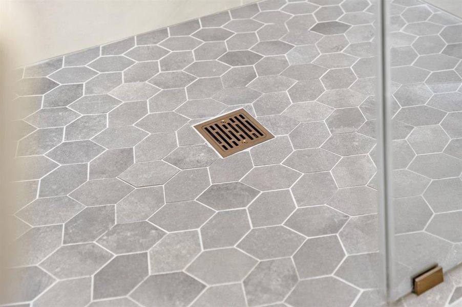 Hexagonal floor tiles in a neutral tone with a contrasting light grout