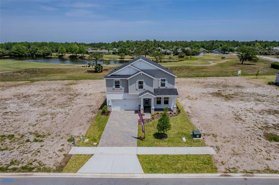 Front exterior of a new home in Gray Hawk at Hole Two, Daytona Beach, FL, highlighting curb appeal (Image 30). Front exterior of a new home in Gray Hawk at Hole Two, Daytona Beach, FL, highlighting curb appeal (Image 30).
