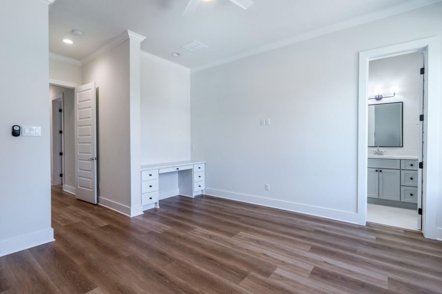 The fifth bedroom located upstairs features a built-in desk and ensuite bathroom. The fifth bedroom located upstairs features a built-in desk and ensuite bathroom.