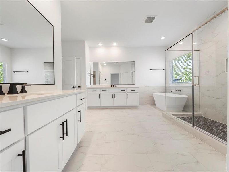 Step into the spa-like Primary Bath! The space features two vanities, custom cabinets, and stunning quartz countertops. (Sample photos of a completed Warwick floor plan. The image may feature alternative selections and/or upgrades.)