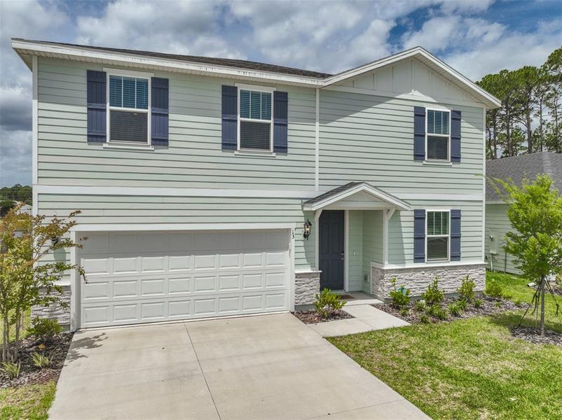 Front exterior of a new home in , Palm Coast, FL, highlighting curb appeal (Image 2). Front exterior of a new home in , Palm Coast, FL, highlighting curb appeal (Image 2).