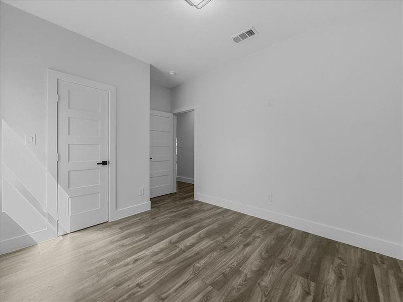 Unfurnished bedroom with light wood-style floors and baseboards Unfurnished bedroom with light wood-style floors and baseboards