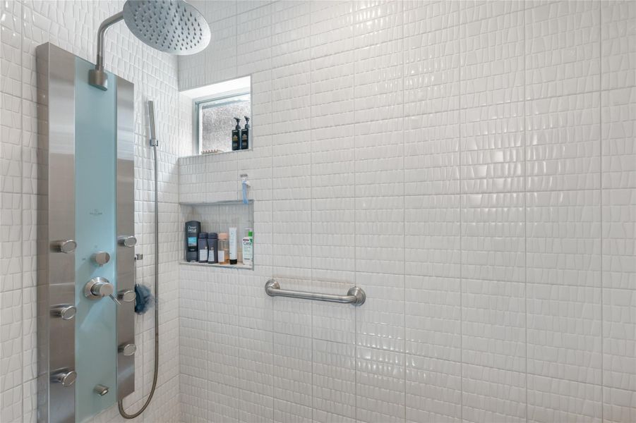 Experience daily luxury in this meticulously tiled shower, complete with an advanced multi-function shower system. Experience daily luxury in this meticulously tiled shower, complete with an advanced multi-function shower system.