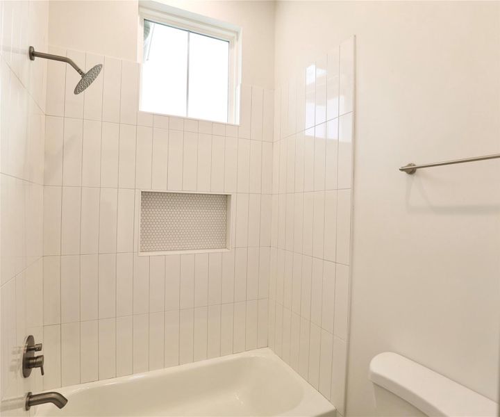 Guest shower is brilliantly finished with 4x16 tiles + custom sized large shower nook. Guest shower is brilliantly finished with 4x16 tiles + custom sized large shower nook.