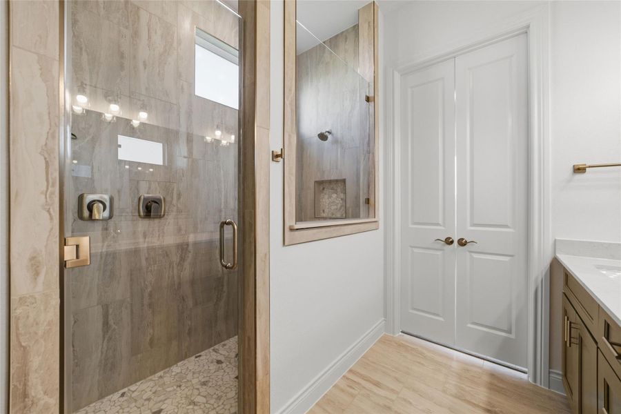 A spacious mega shower paired with double vanity sinks creates a luxurious, spa-like primary bathroom.