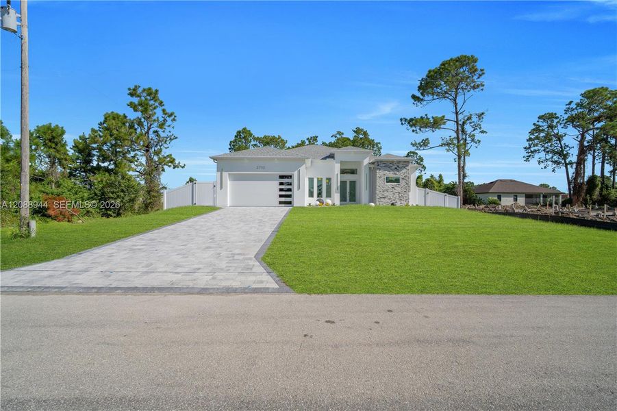 Front exterior of a new home in , Lehigh Acres, FL, highlighting curb appeal (Image 25).