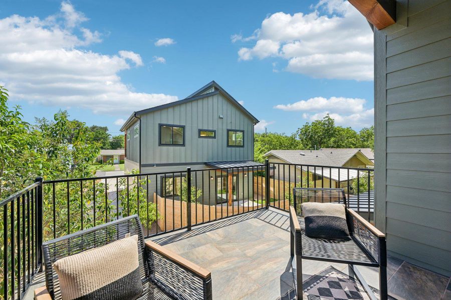 Enjoy outdoor living on this elevated patio featuring tiled flooring and a sturdy railing. Enjoy outdoor living on this elevated patio featuring tiled flooring and a sturdy railing.