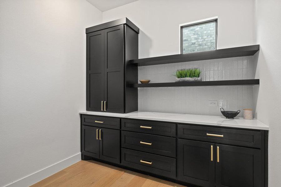 The butler's pantry off the kitchen features a convenient cafe counter and ample cabinetry.