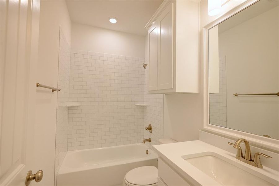 Full bath with vanity, washtub / shower combination, and recessed lighting Full bath with vanity, washtub / shower combination, and recessed lighting