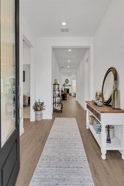 Corridor featuring recessed lighting and light wood-style floors