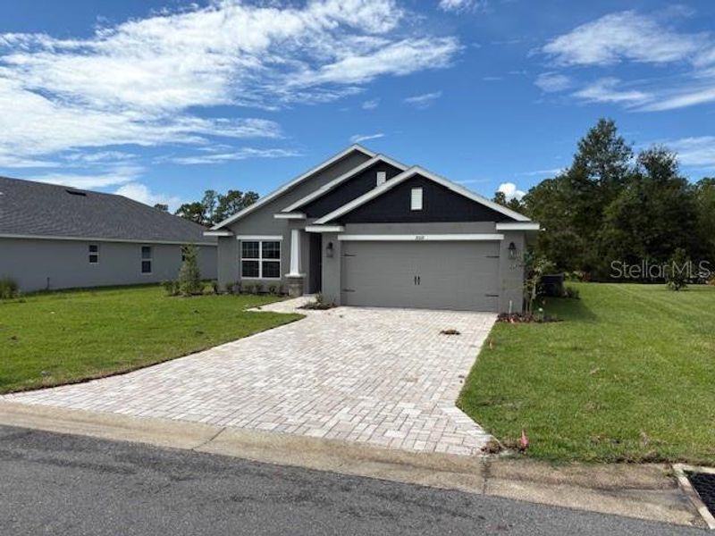 Front exterior of a new home in Juliette Falls, Dunnellon, FL, highlighting curb appeal (Image 2). Front exterior of a new home in Juliette Falls, Dunnellon, FL, highlighting curb appeal (Image 2).