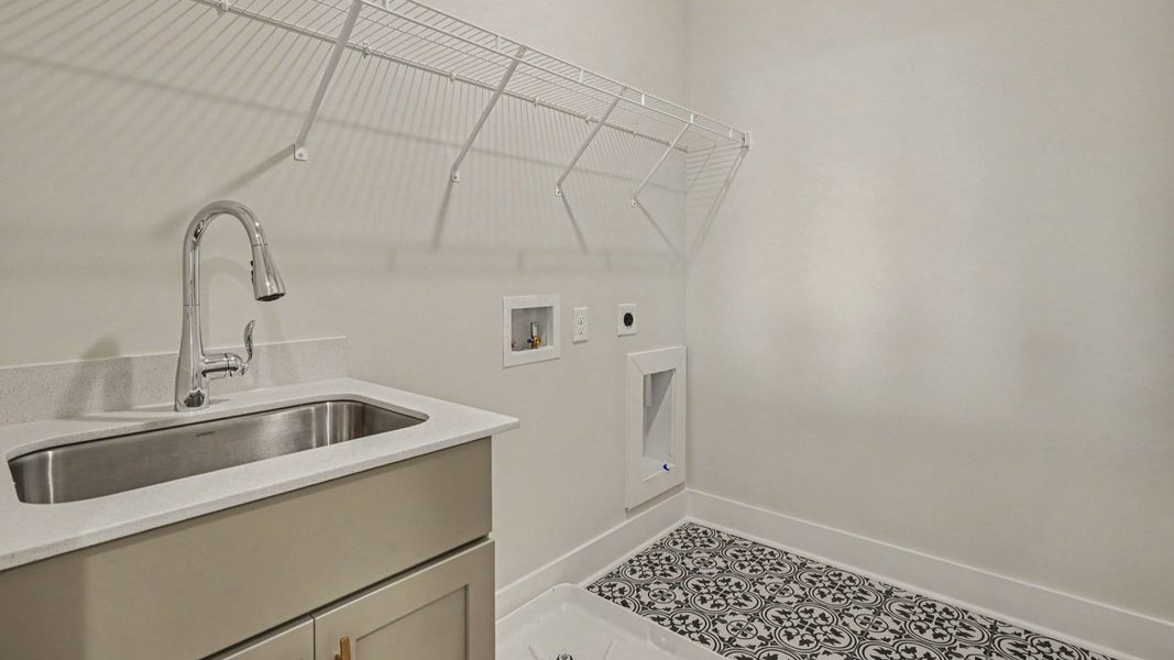 Dedicated laundry room with elevated floor tiling Dedicated laundry room with elevated floor tiling