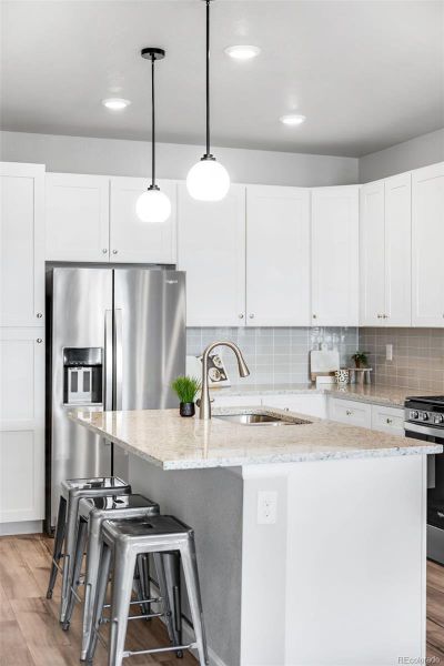 New matte black pendants hang above the island