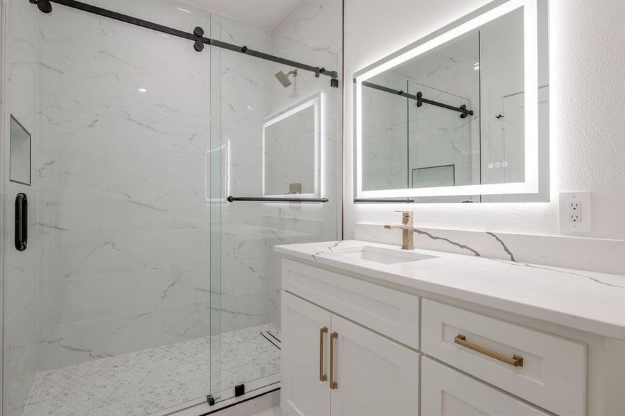 Bathroom with vanity and a marble finish shower Bathroom with vanity and a marble finish shower