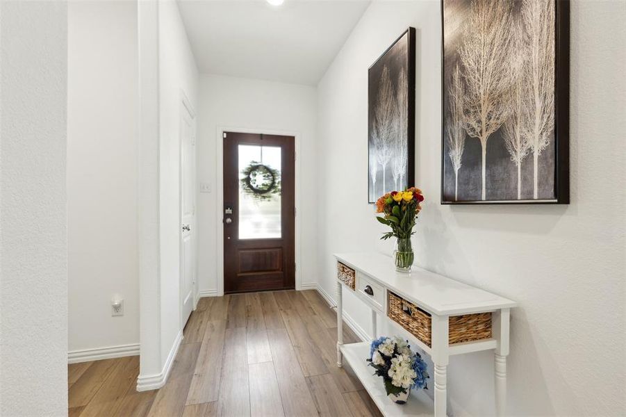 Entrance foyer featuring light hardwood / wood-style floors