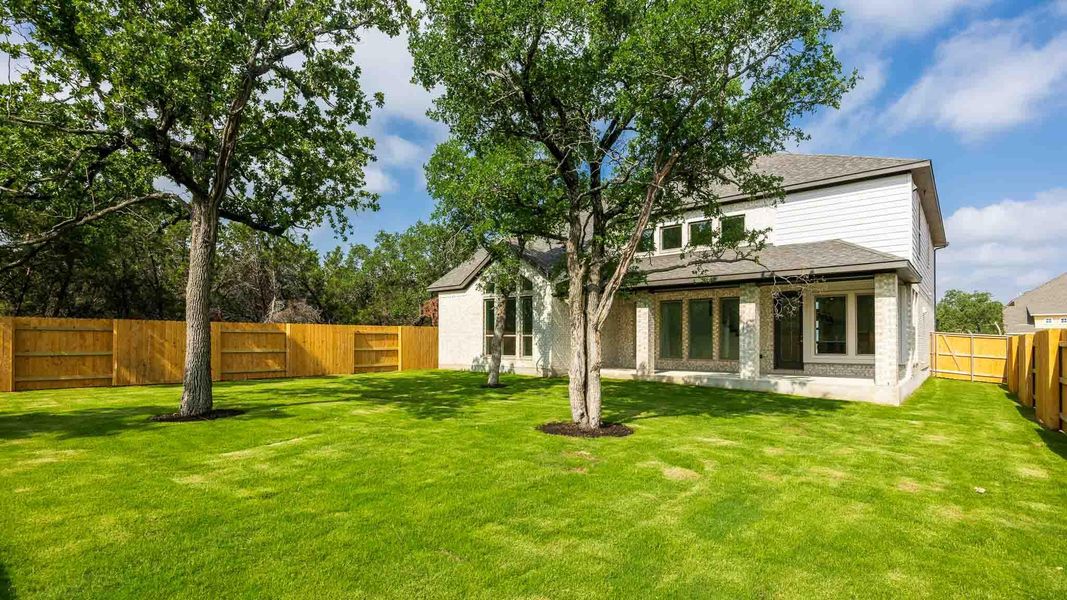 Rear view of property with roof with shingles and brick siding Rear view of property with roof with shingles and brick siding
