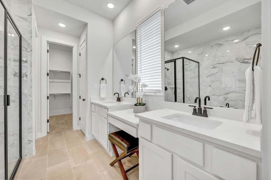 Bathroom with recessed lighting, a marble finish shower, a walk in closet, and vanity