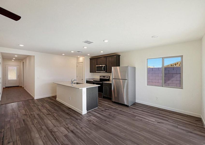 Enjoy stunning granite countertops and designer wood cabinetry in this kitchen.