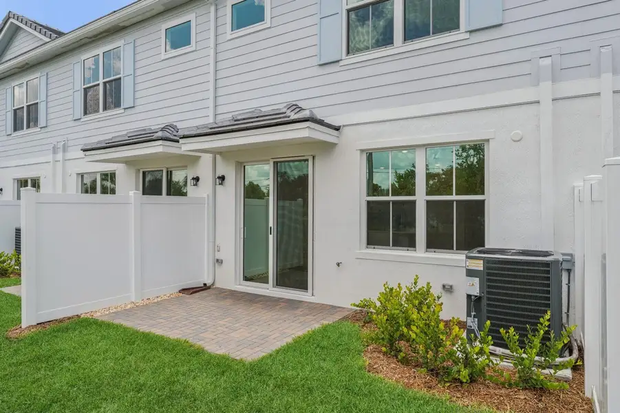 Front exterior of a new home in Salerno Reserve Townhomes, Stuart, FL, highlighting curb appeal (Image 1).
