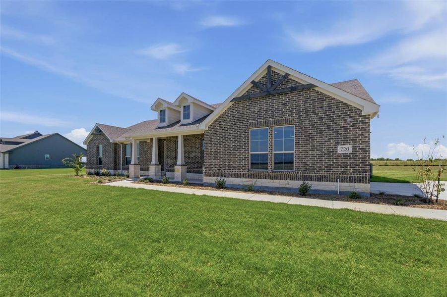 Brick exterior with light stone accents, featuring a covered front porch with multiple columns Brick exterior with light stone accents, featuring a covered front porch with multiple columns