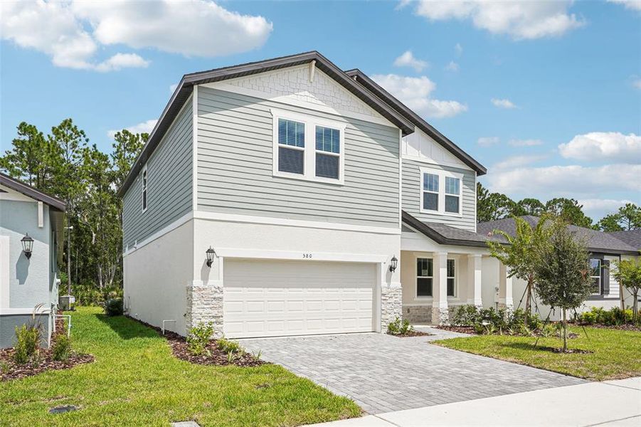Front exterior of a new home in Ridgehaven - Signature Series, Ormond Beach, FL, highlighting curb appeal (Image 24).