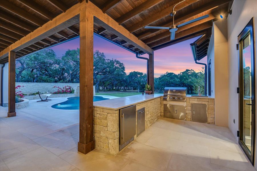 View of patio featuring an outdoor kitchen and a ceiling fan View of patio featuring an outdoor kitchen and a ceiling fan