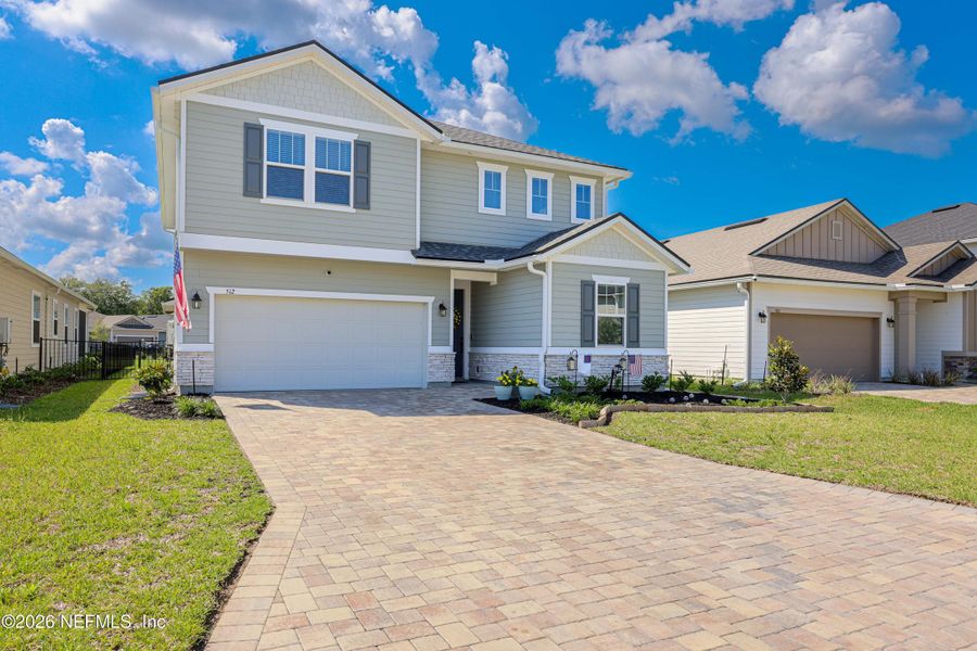 Front exterior of a new home in Elm Creek at Silverleaf, St. Augustine, FL, highlighting curb appeal (Image 1). Front exterior of a new home in Elm Creek at Silverleaf, St. Augustine, FL, highlighting curb appeal (Image 1).