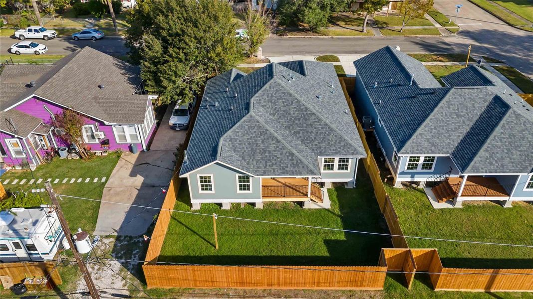Aerial look at the fenced backyard and lot layout, showcasing outdoor space and property boundaries.
