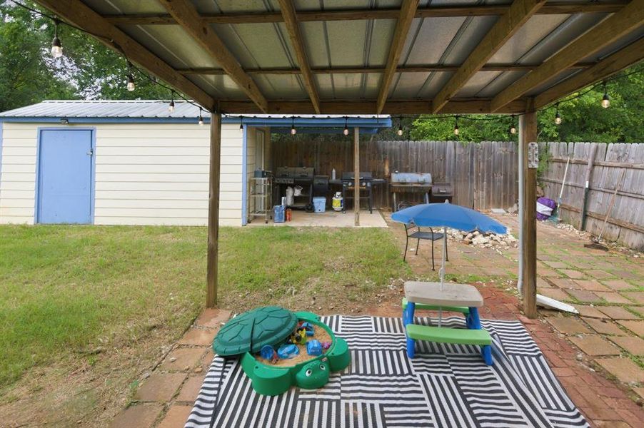 Covered patio featuring a metal roof and string lighting