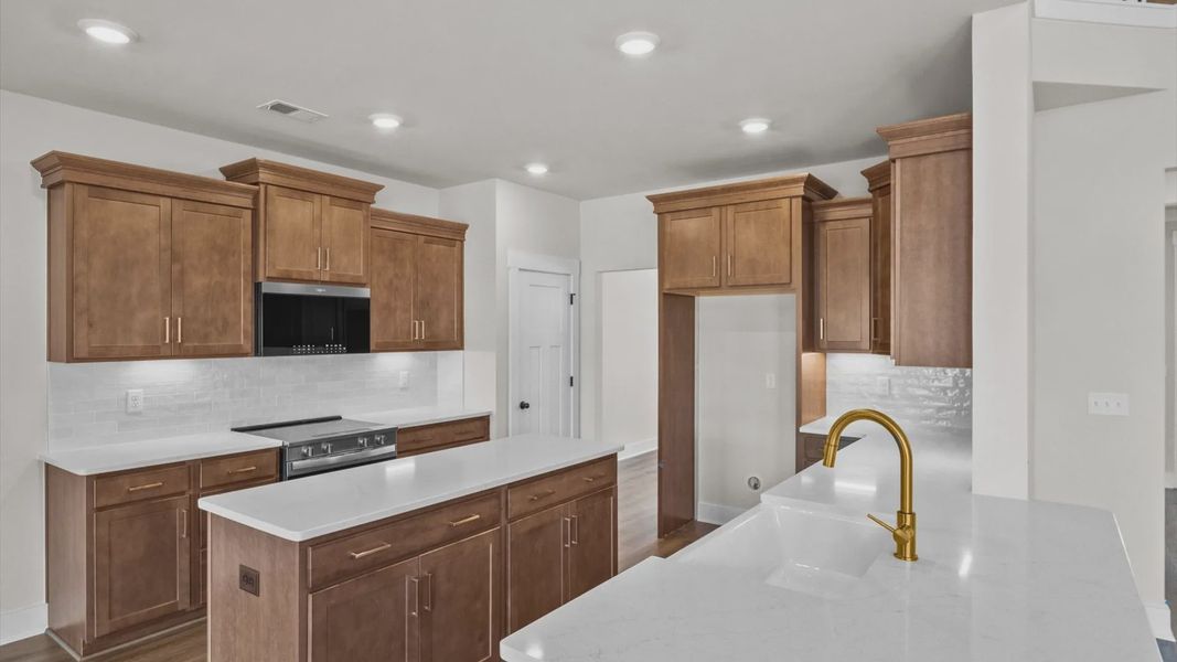 Well-designed kitchen with a center island and tasteful finishes that elevate everyday living at Benjamin's Grove