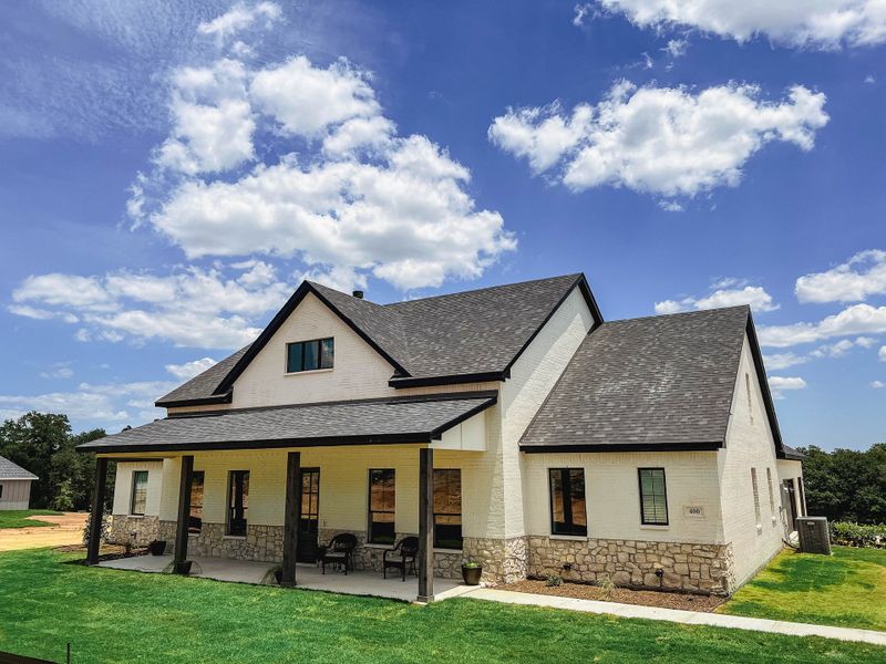 Representative exterior photo of a completed home built from the Ashwood Court House by Trinity Classic Homes in The Reserve at Shadle, Poolville, TX (Image 16). Representative exterior photo of a completed home built from the Ashwood Court House by Trinity Classic Homes in The Reserve at Shadle, Poolville, TX (Image 16).