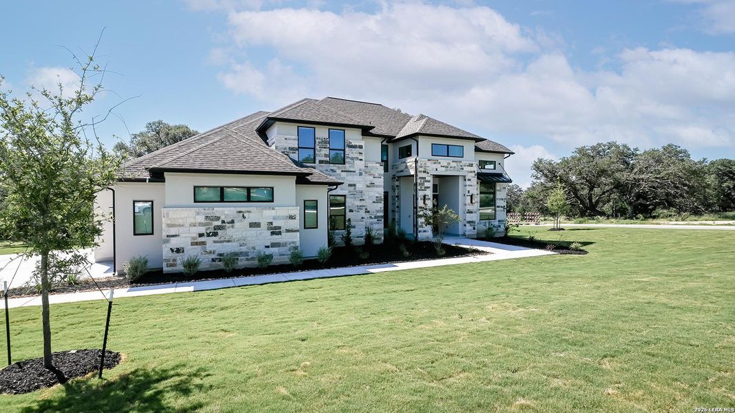 Front exterior of a new home in Thornebrook, Bulverde, TX, highlighting curb appeal (Image 2). Front exterior of a new home in Thornebrook, Bulverde, TX, highlighting curb appeal (Image 2).