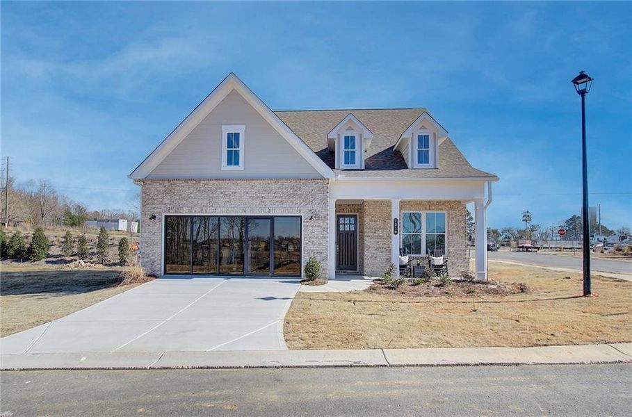 Front exterior of a new home in Courtyards at Traditions, Cumming, GA, highlighting curb appeal (Image 1).